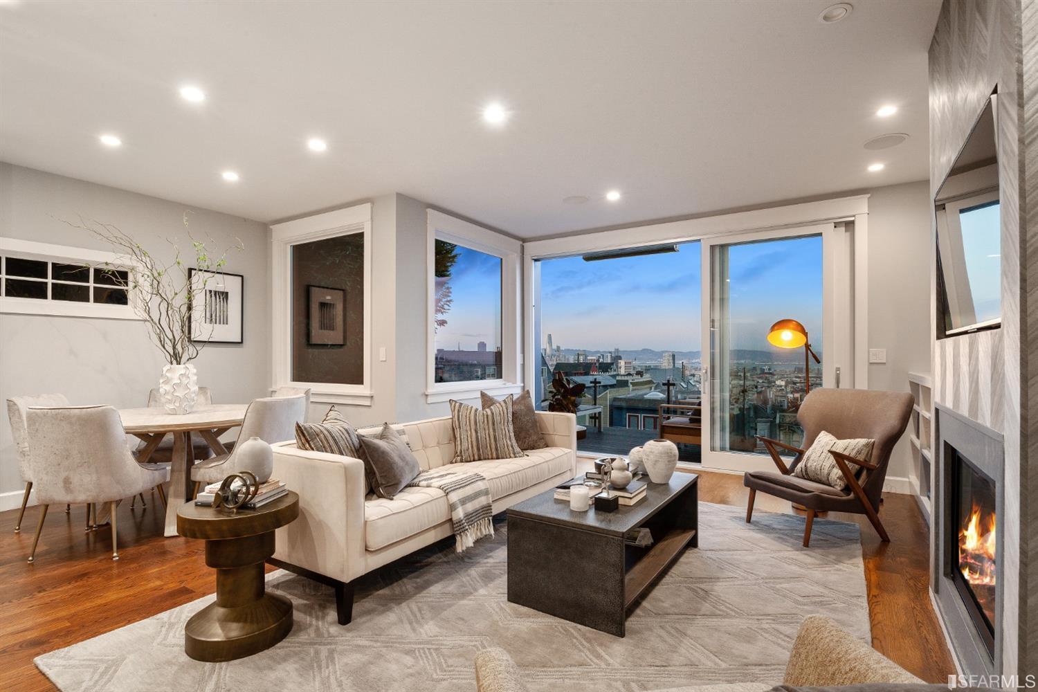 Gray and White living room overlooking SF at night